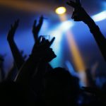 A lively nightclub scene with a crowd raising their hands, creating a vibrant nightlife atmosphere.